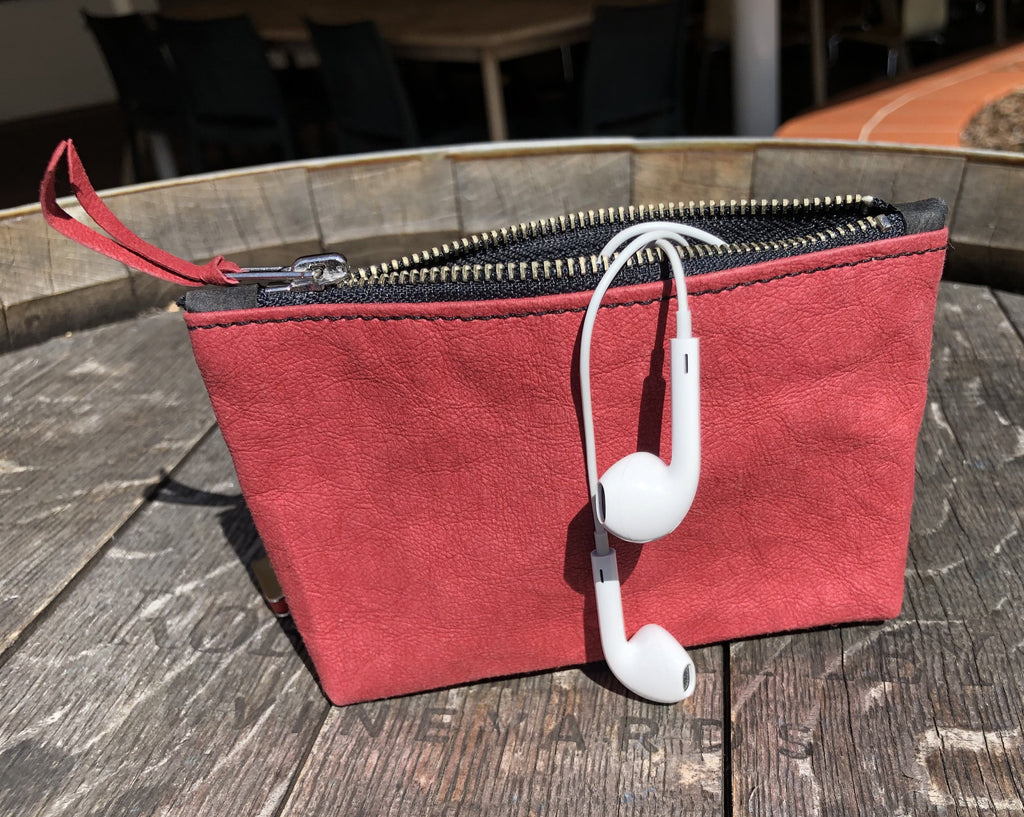Multi-functional coin purse for electronic cords and earphones.